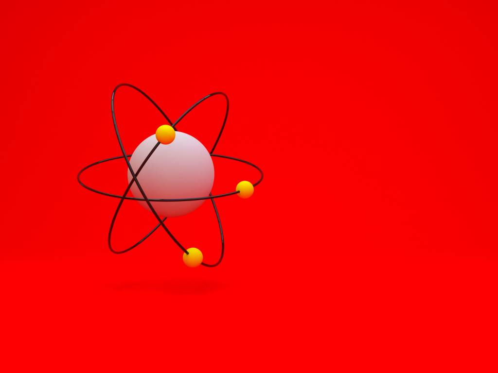 Model of atom with shadow on red background, 3D Como revisar Ciências da Natureza para o Enem