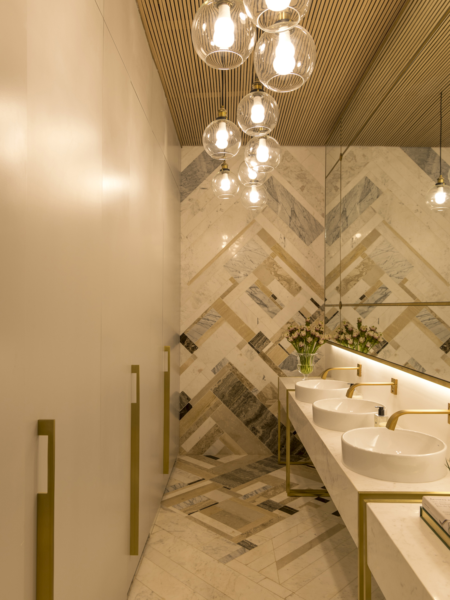 Aparas de m&aacute;rmore revestem parede e piso de banheiro na CASACOR SP